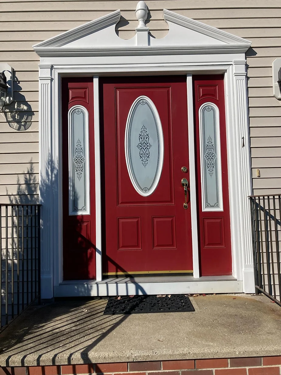 For this front door restoration in Haverhill, MA, Our handyman painted the door red and finished with white trim. He also added a door sweep to save heating costs and keep out dirt and insects .

